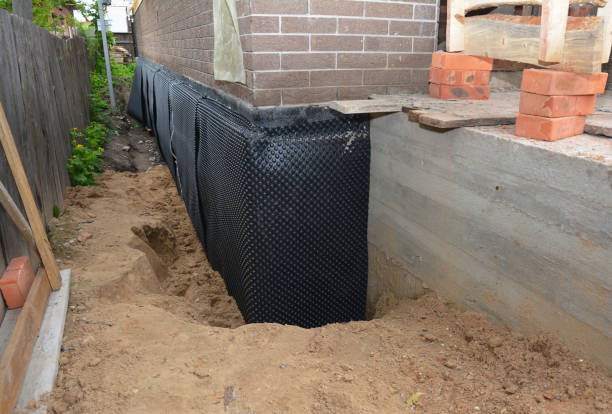 SJ Waterproofing Pros technician performing targeted Wet Basement Repair assessment in Freeport, MI